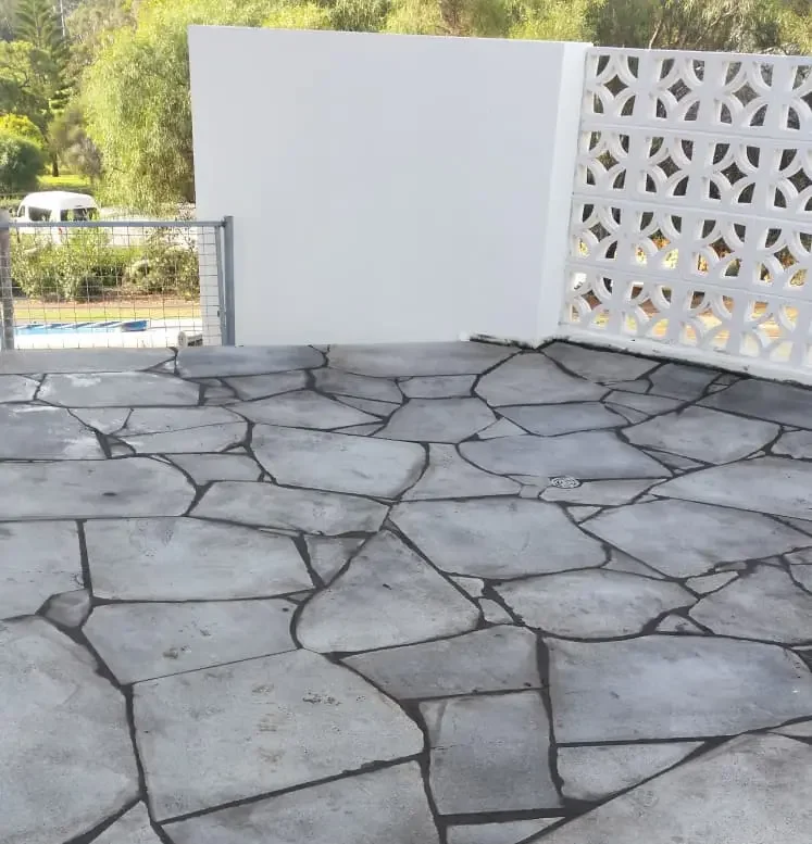 Natural crazy paving stone installed around a residential swimming pool in Perth
