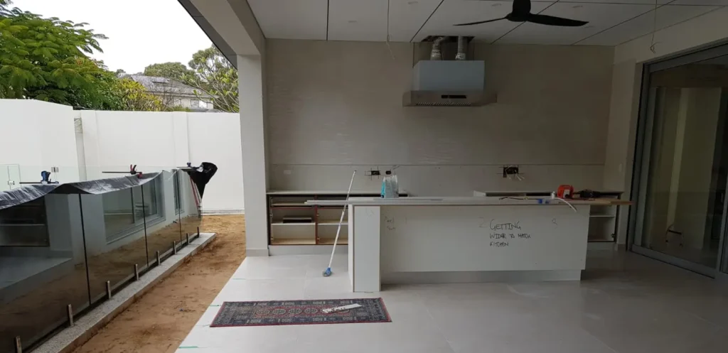 Modern kitchen and adjoining alfresco area with professionally installed porcelain floor tiles in Perth